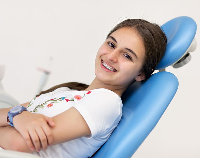 Teenage girl sitting in a dentist chair